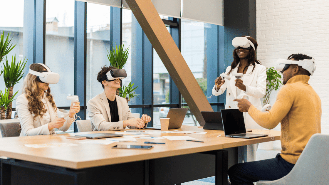 four people wearing VR headsets in a work enviroment 