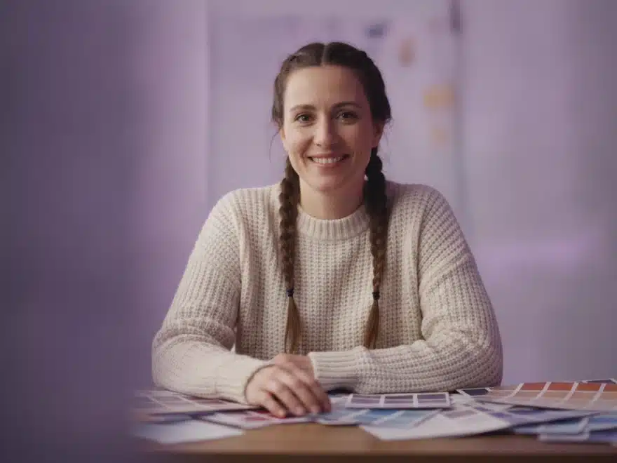 A brand designer at her desk applying brand colors to the captions of a video in Pictory