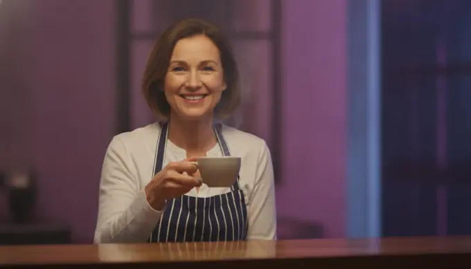A cafe owner behind her counter in a local business video ad for Facebook