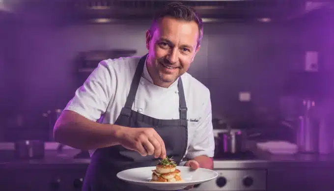A chef plating a dish in a restaurant kitchen in a cooking video dubbed by Pictory