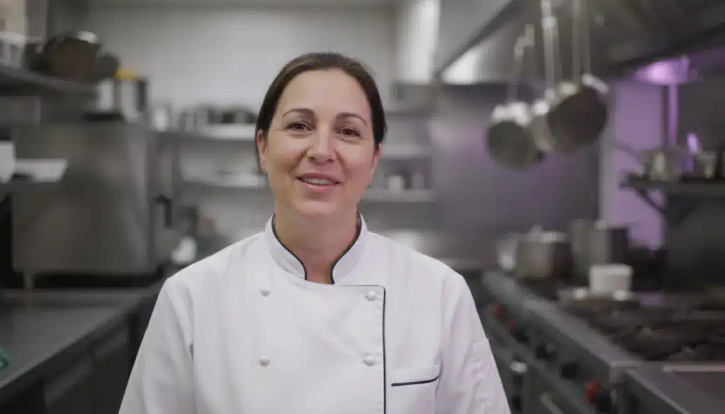 A chef talking to the camera in a restaurant kitchen in a cooking video dubbed into French by Pictory