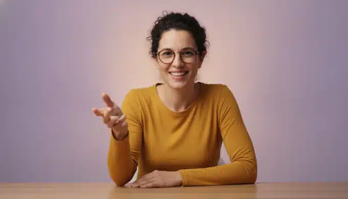 A coding instructor at a desk in a course video with subtitles generated by Pictory