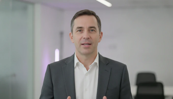 A communications manager in a company update video with AI voiceovers in several languages