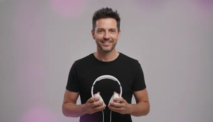 A consumer electronics founder holding wireless headphones in a product launch video