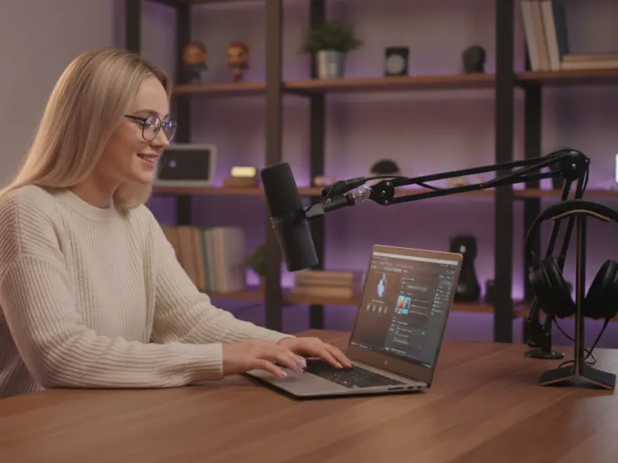 Creator at her microphone choosing an AI voice, with her voice clone ready in Pictory