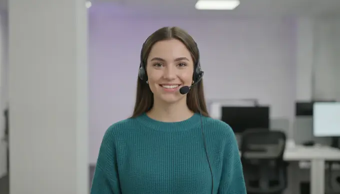 A customer support lead wearing a headset in a how-to video for customers