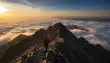 Original clip, frame 1: sunrise over the clouds beside a mountain ridge