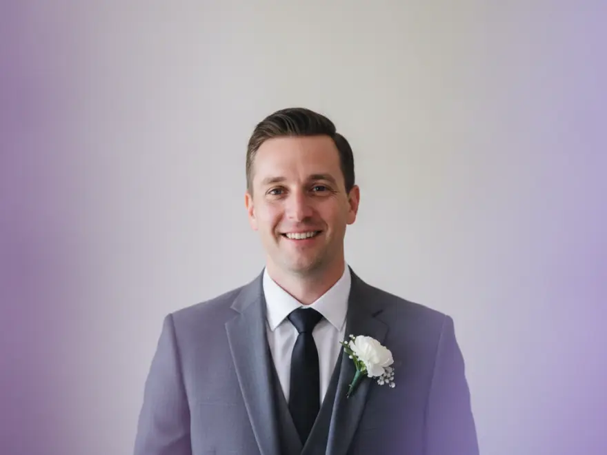 Groom in a grey suit in a wedding video with a caption from the speeches
