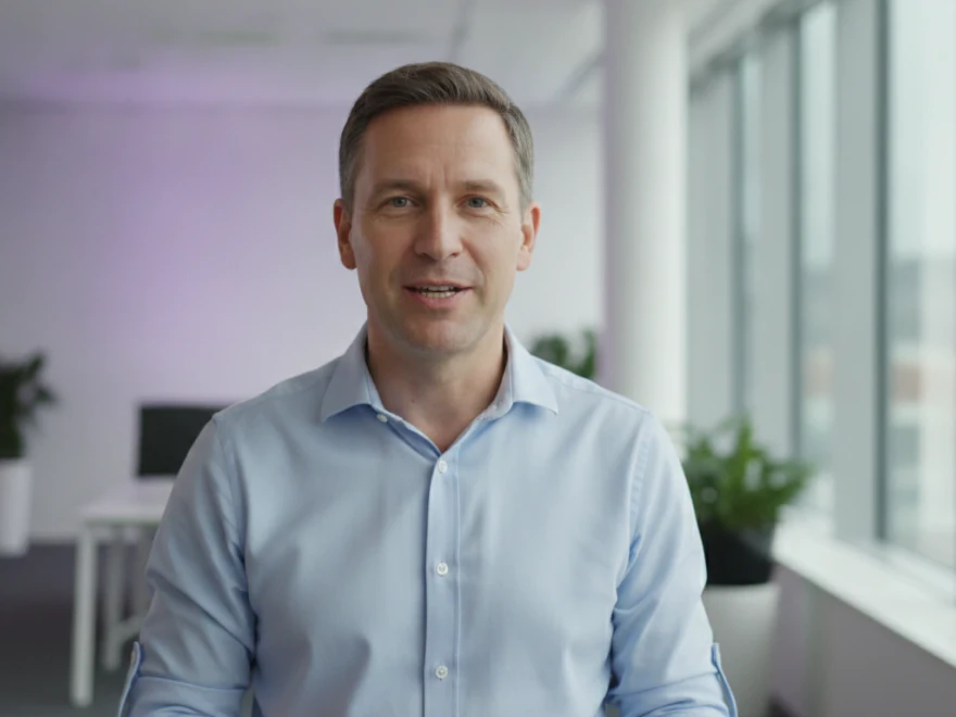A head of people in a modern office talking to the camera in a LinkedIn video with captions and brand colors