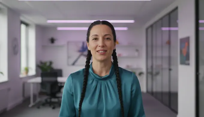 An internal communications lead in a company update video read by a video narrator