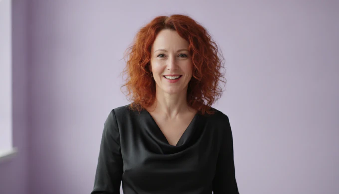 A marketing team lead in a bright studio, with a shared brand kit for her team in Pictory