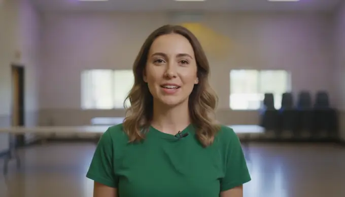 A nonprofit coordinator sharing a volunteer update as an AI avatar in a community hall