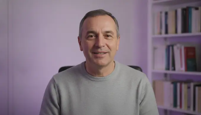 An online teacher in his home office in an intro for a course lesson