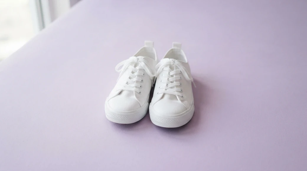 A pair of white sneakers on a lilac background, generated with Nano Banana Lite in Pictory