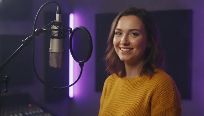 A presenter beside a studio microphone in a marketing video made from her recorded voiceover, with wide, vertical and square formats