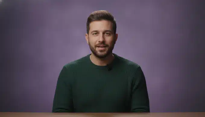 A product manager at a desk in a product tour video with subtitles translated by Pictory
