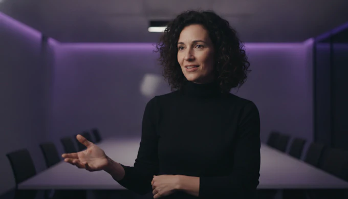 A product marketer presenting in a meeting room in a LinkedIn video made from slides