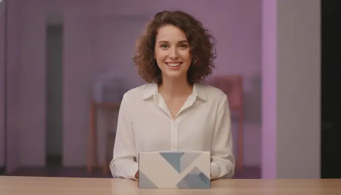 A product marketer smiling beside a product box in a demo video narrated by an AI voice