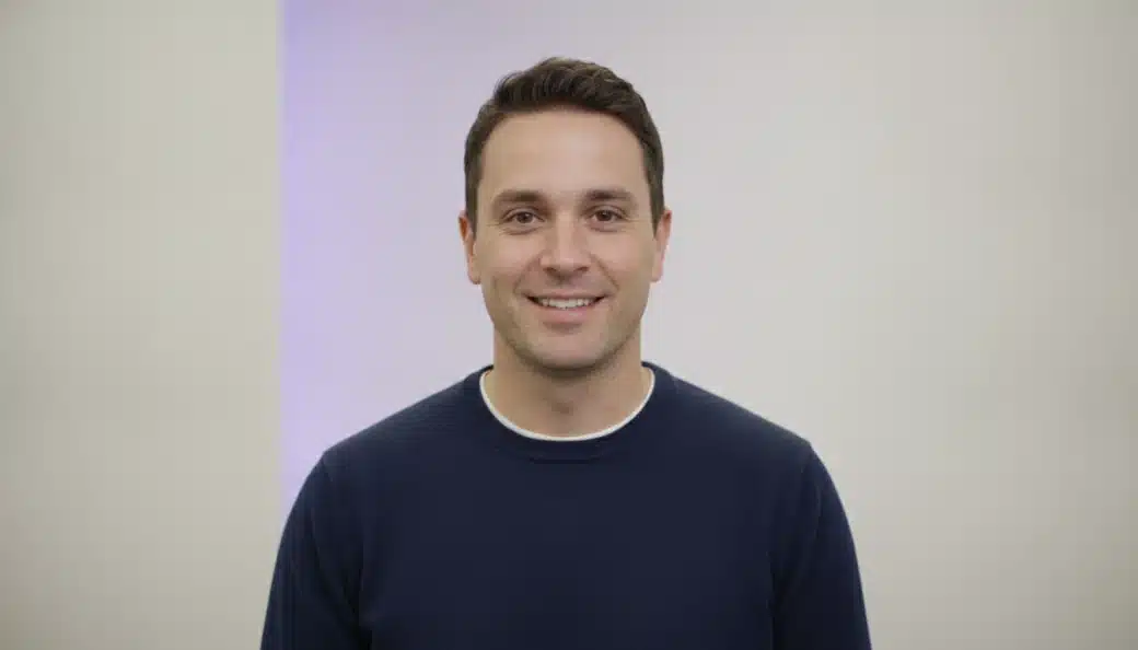 A product trainer talking to the camera in a bright office, with captions added by Pictory