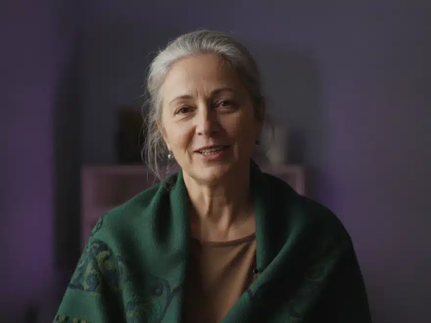 A storyteller talking to the camera in a short video summary of her story, with captions on