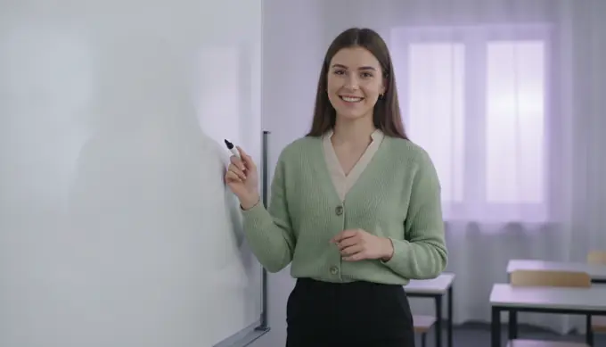 A teacher in her classroom in a lesson video made from her course notes