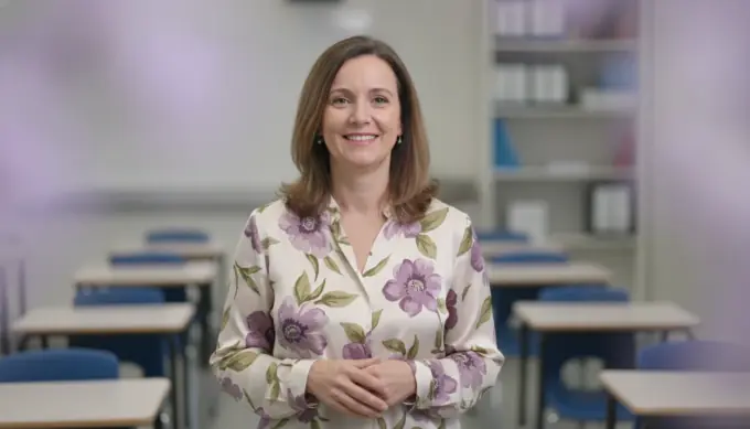 A teacher smiling in a lesson video made from a topic she typed