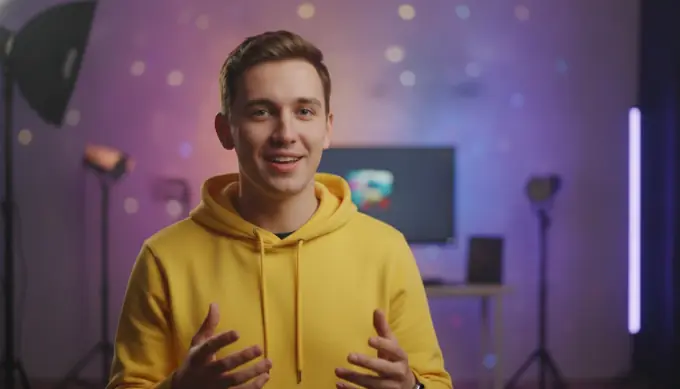 A young presenter in a yellow hoodie talking to the camera as an AI avatar in a social video